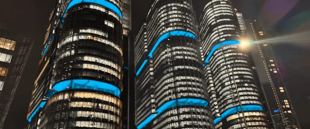 Sydney office towers at night wrapped in blue light bands